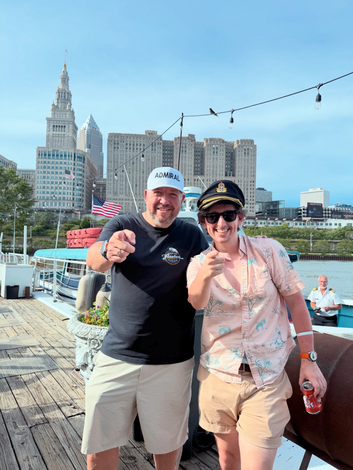 Admiral Jim and a guest pointing at the camera on the Cleveland Floaters dock