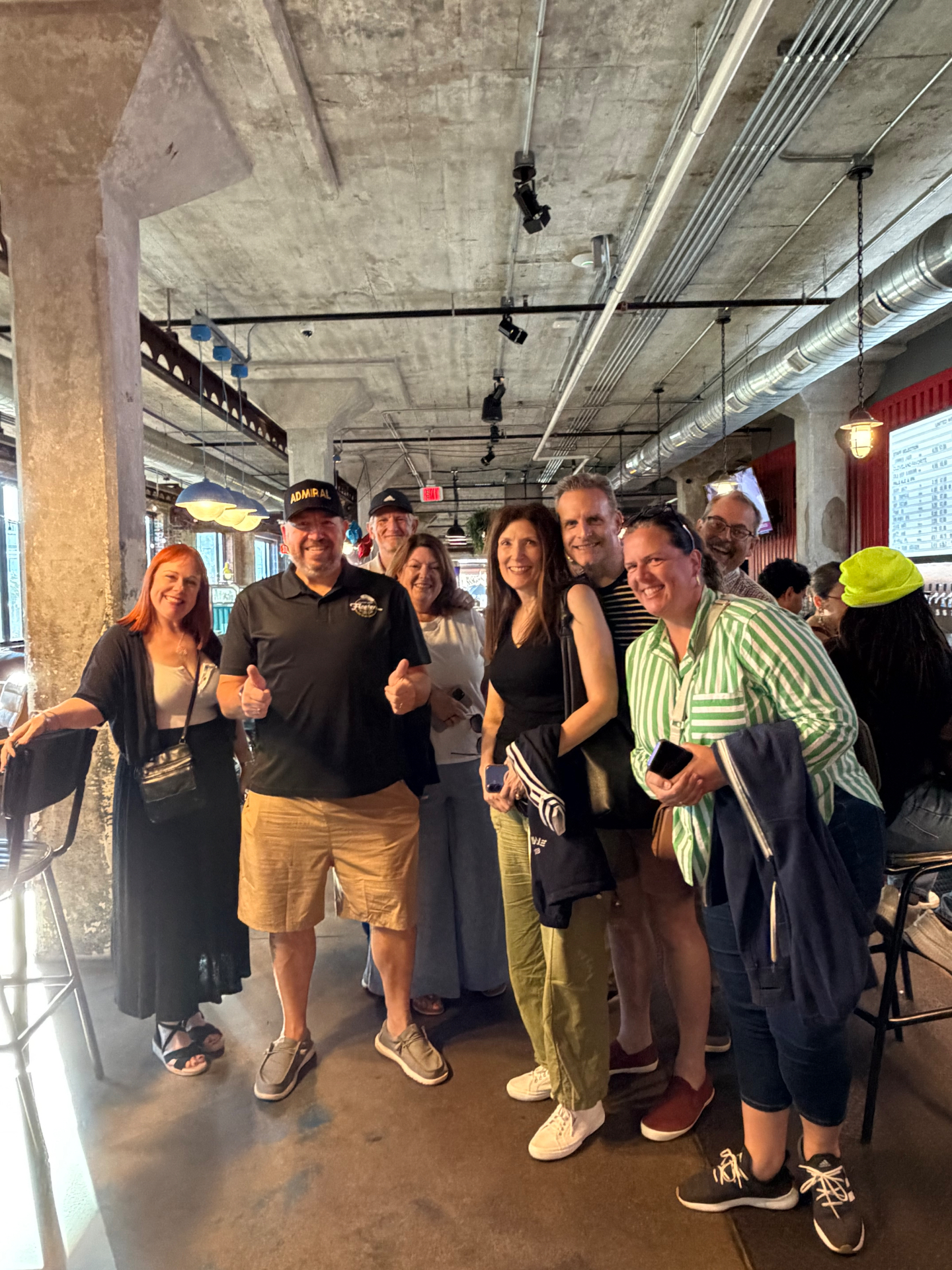 Admiral Jim with a group of guests indoors